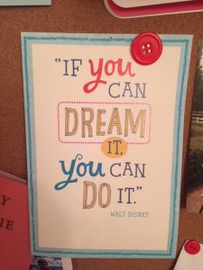 Card pinned on bulletin board that reads 'If you can dream it, you can do it' by Walt Disney